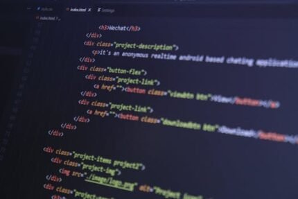Close-up of HTML code with syntax highlighting on a computer monitor.